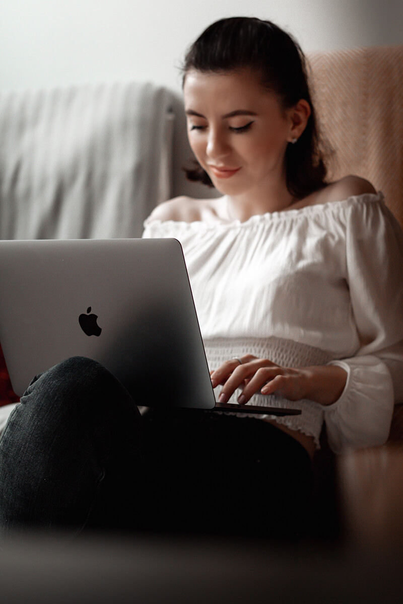 A girl on a Macbook laptop.