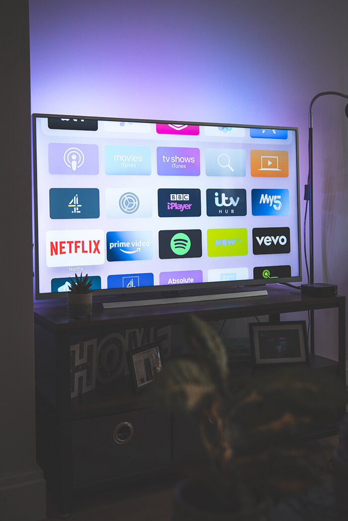 A TV showing a home screen with various streaming apps, including Netflix and Prime Video.