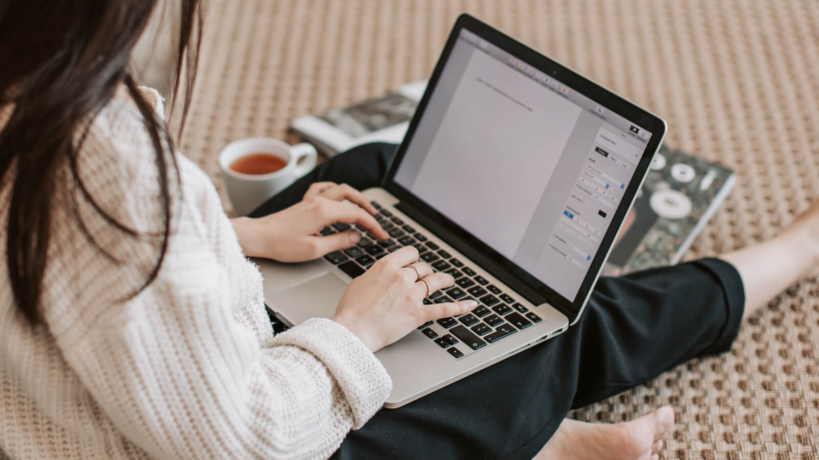 Young woman typing into a text document on a laptop